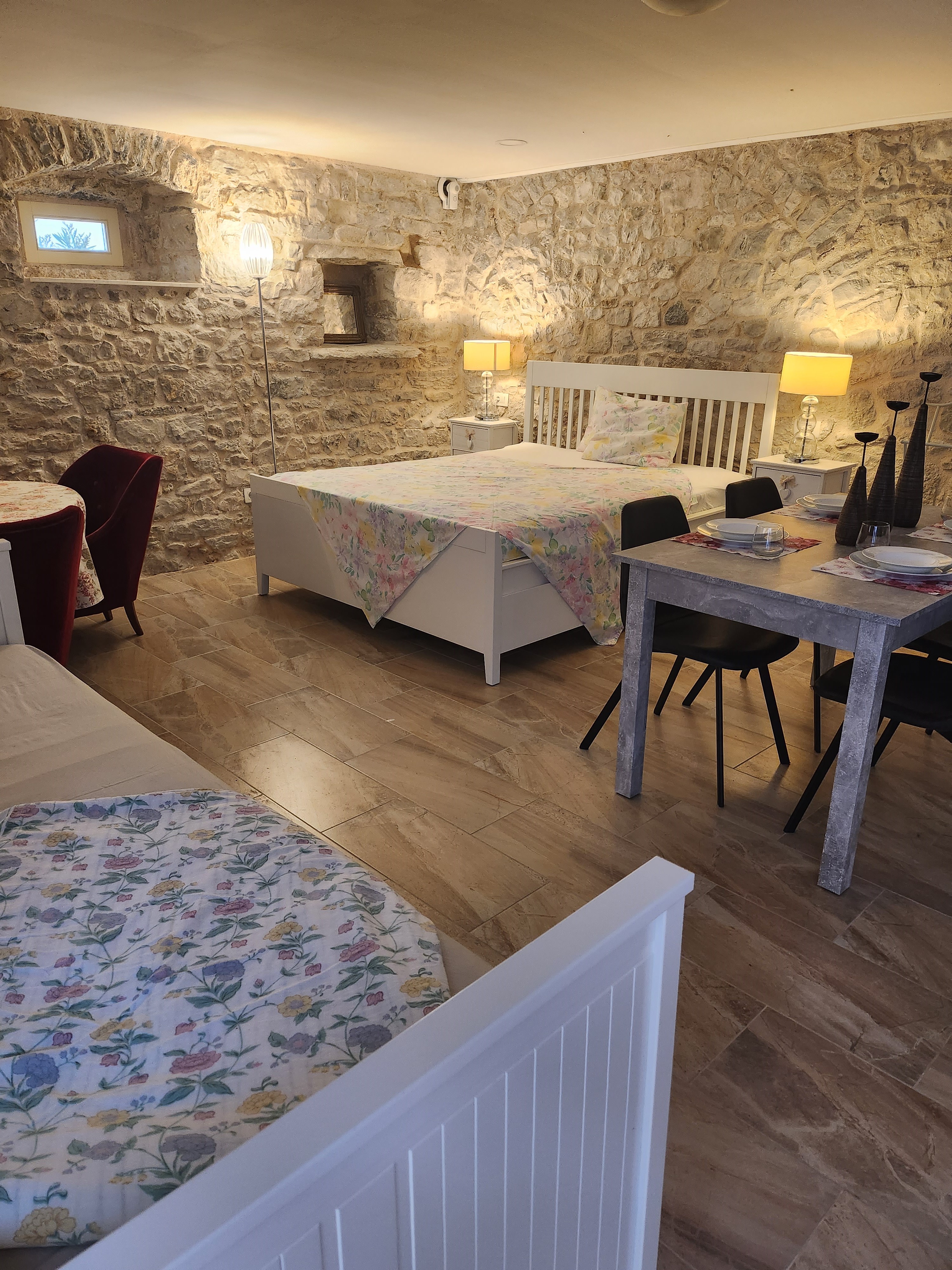 Rodinný apartmán — kamenné stěny, dvojlůžko a stolování